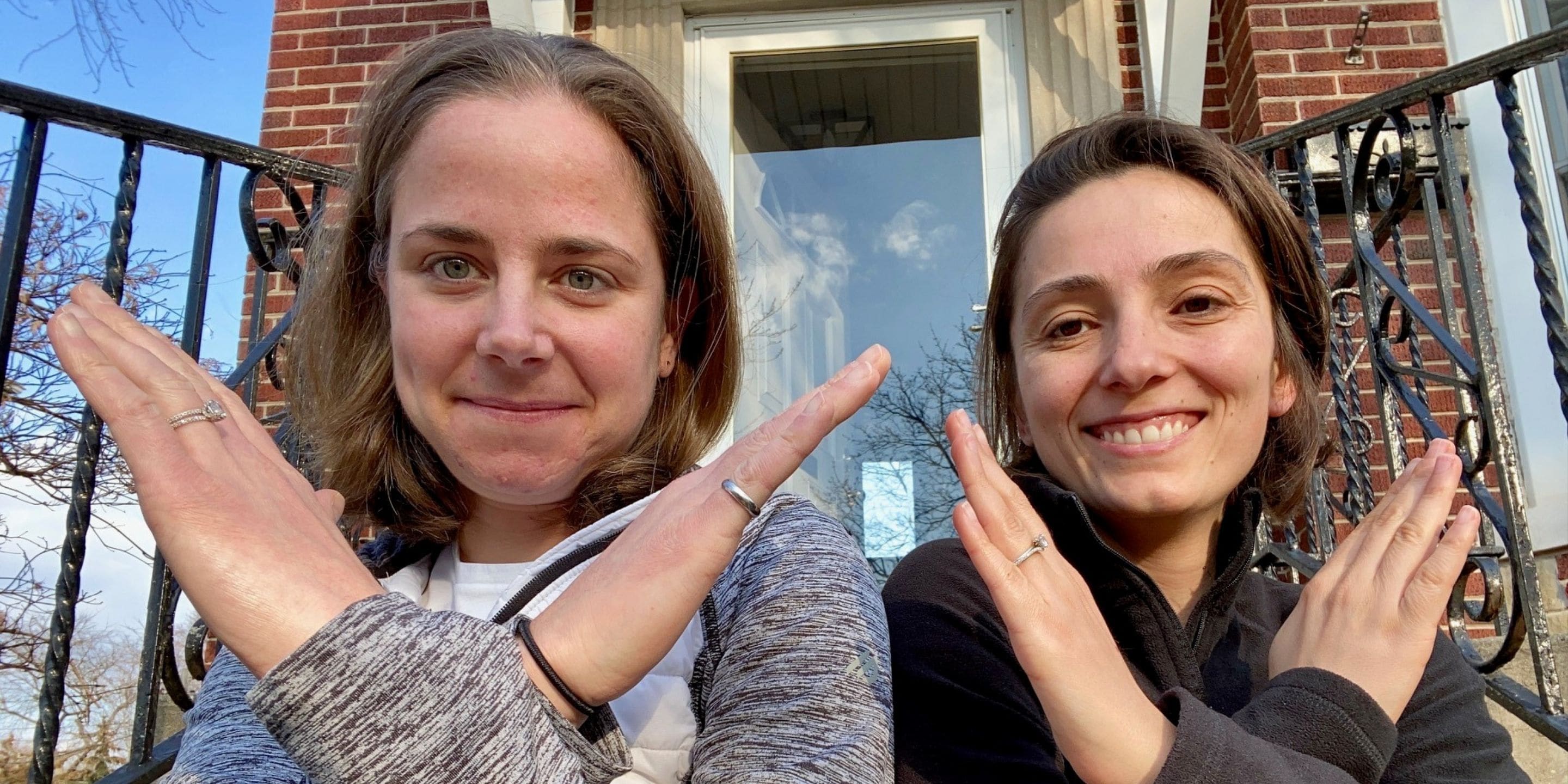 Beth Carter (left) and Helin Cox (right) pose with the International Women's Day #BreakTheBias symbol.